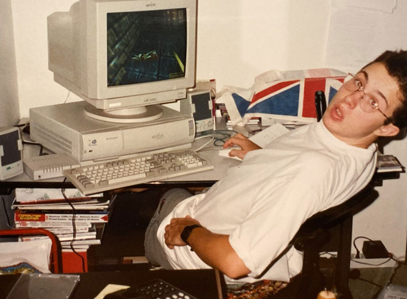 A photo of a younger me playing Daggerfall on a beige PC in 1996.