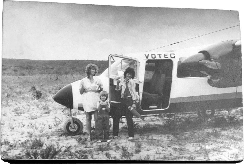 Black and white photograph of my mother, my cousin and I by a Britten-Norman BN-2 Islander aircraft on a potato field.