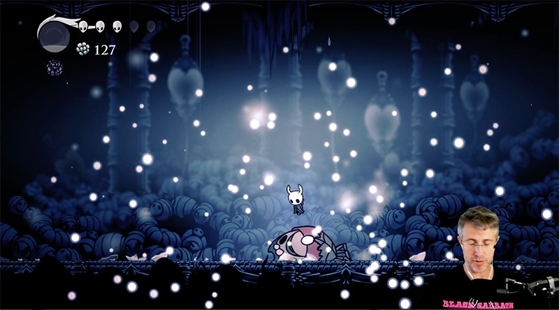 A screenshot of Hollow Knight linked to the HyperTextHero Hollow Knight YouTube playlist.