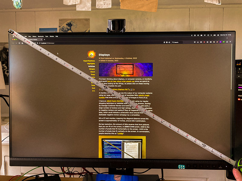 A photo of the Asus ProArt monitor with a measuring tape placed diagonally across the screen.